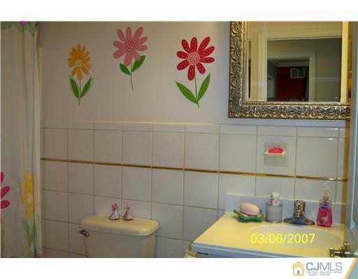 1669 Union Avenue, Unit NONE Hazlet, NJ 07730 - Photo 9 of 10 a bathroom with a sink and a mirror