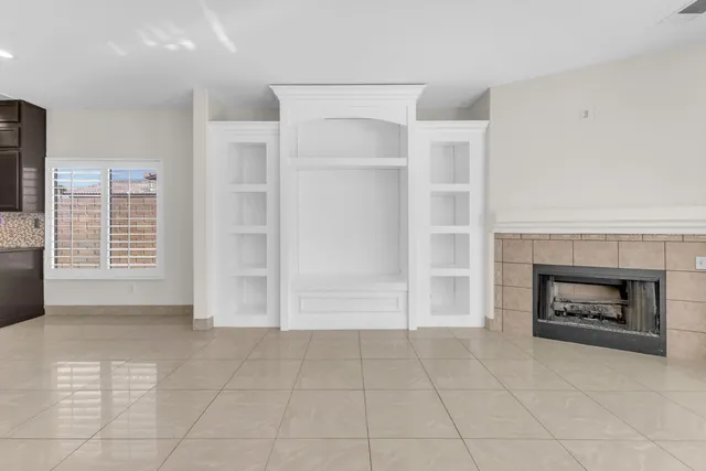 a view of an empty room with a fireplace