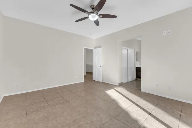 a view of a livingroom with a ceiling fan and window