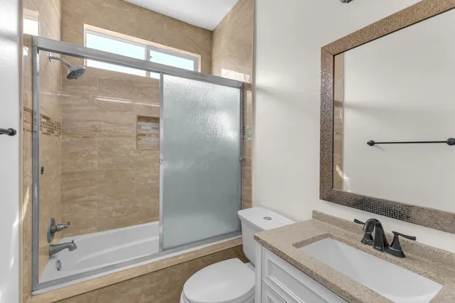 a bathroom with a sink toilet and shower