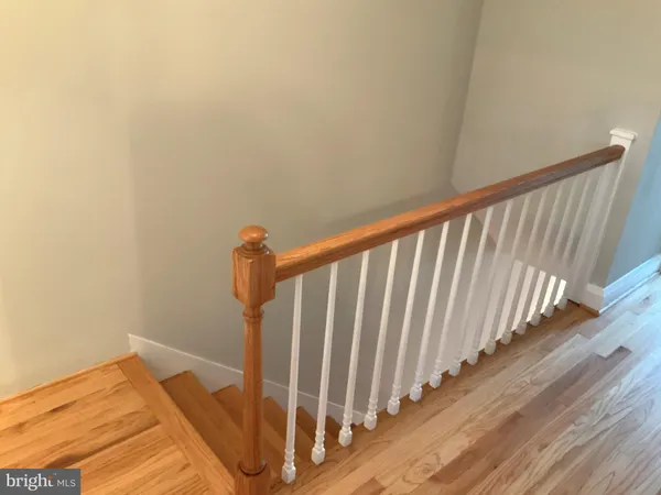 a view of a room with wooden floor and window