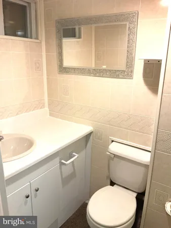 a white toilet sitting next to a shower