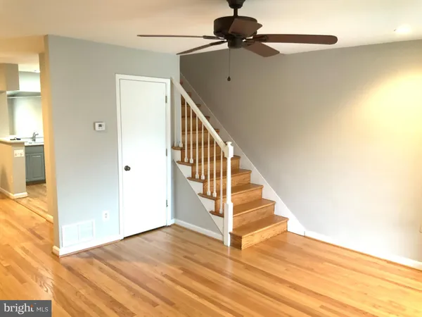a view of entryway and hall with wooden floor