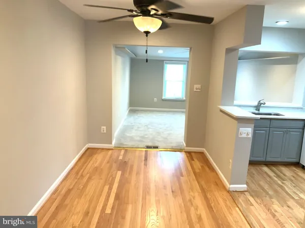 a view of a room with wooden floor and a sink
