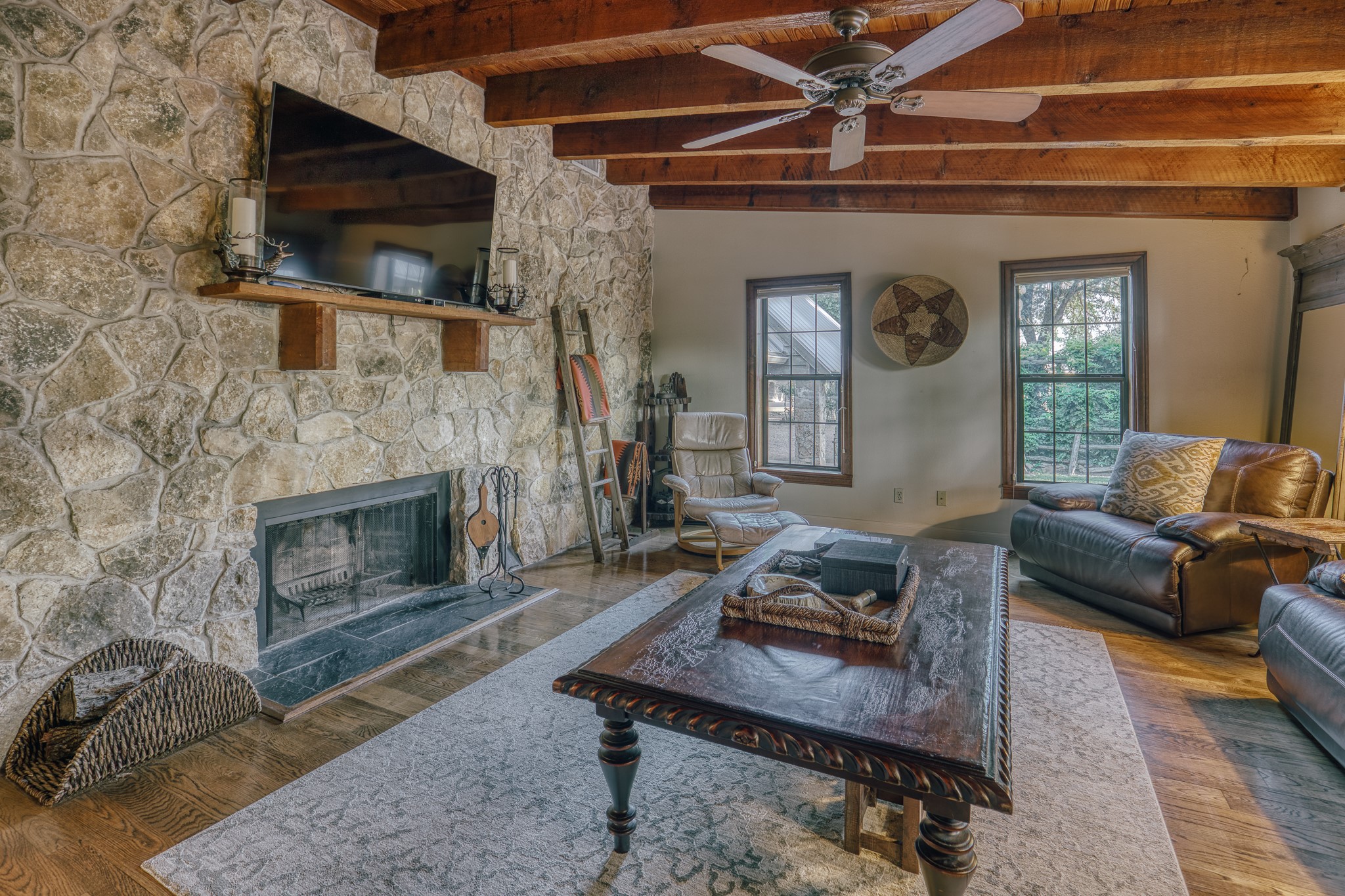 1034 Hilbun Road New Ulm, TX 78950 - Photo 28 of 49 Designed for relaxation and entertaining, the main residence showcases custom stonework, warm wood finishes, inviting living spaces, a pool and spa oasis, covered porches, and picturesque ranch views