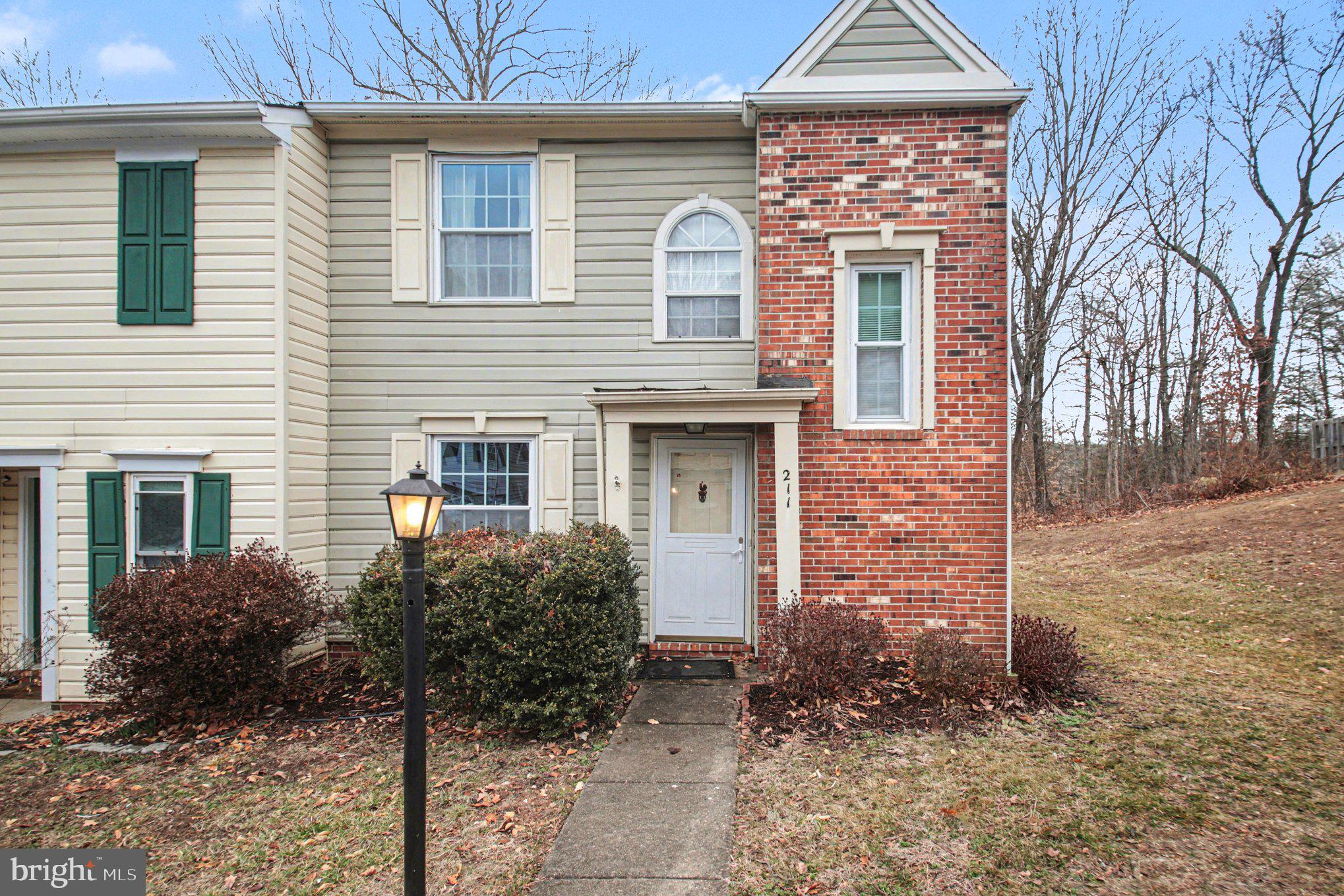 211 Wind Ridge Drive Stafford, VA 22554 - Photo 1 of 27 a front view of a house with garden