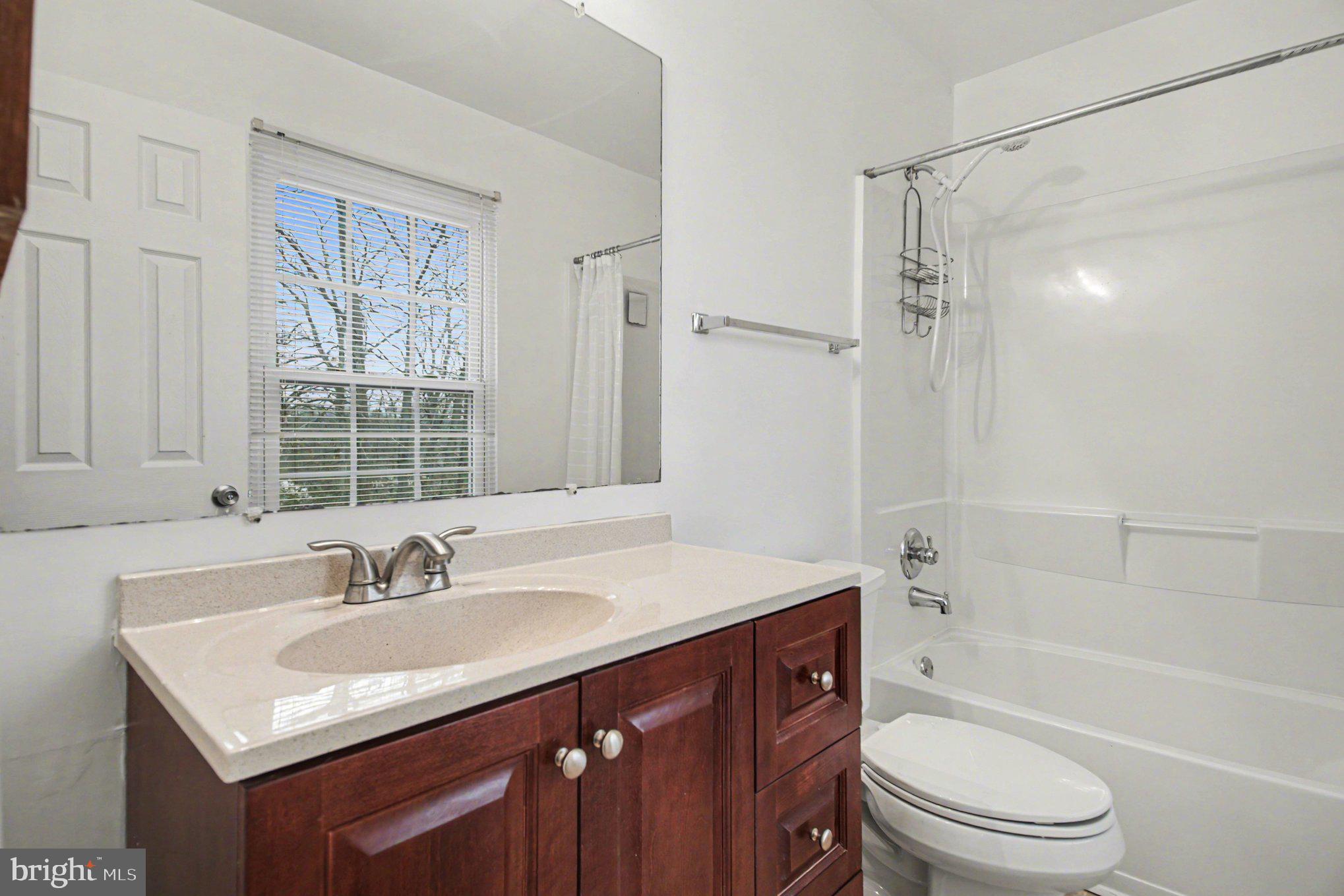 211 Wind Ridge Drive Stafford, VA 22554 - Photo 19 of 27 a bathroom with a sink toilet a vanity and shower