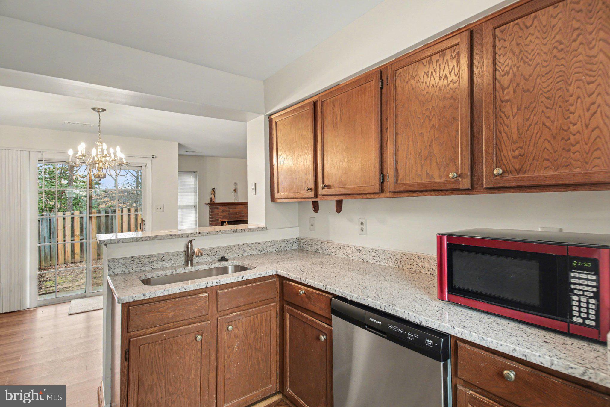 211 Wind Ridge Drive Stafford, VA 22554 - Photo 6 of 27 a kitchen with stainless steel appliances granite countertop a sink stove and microwave