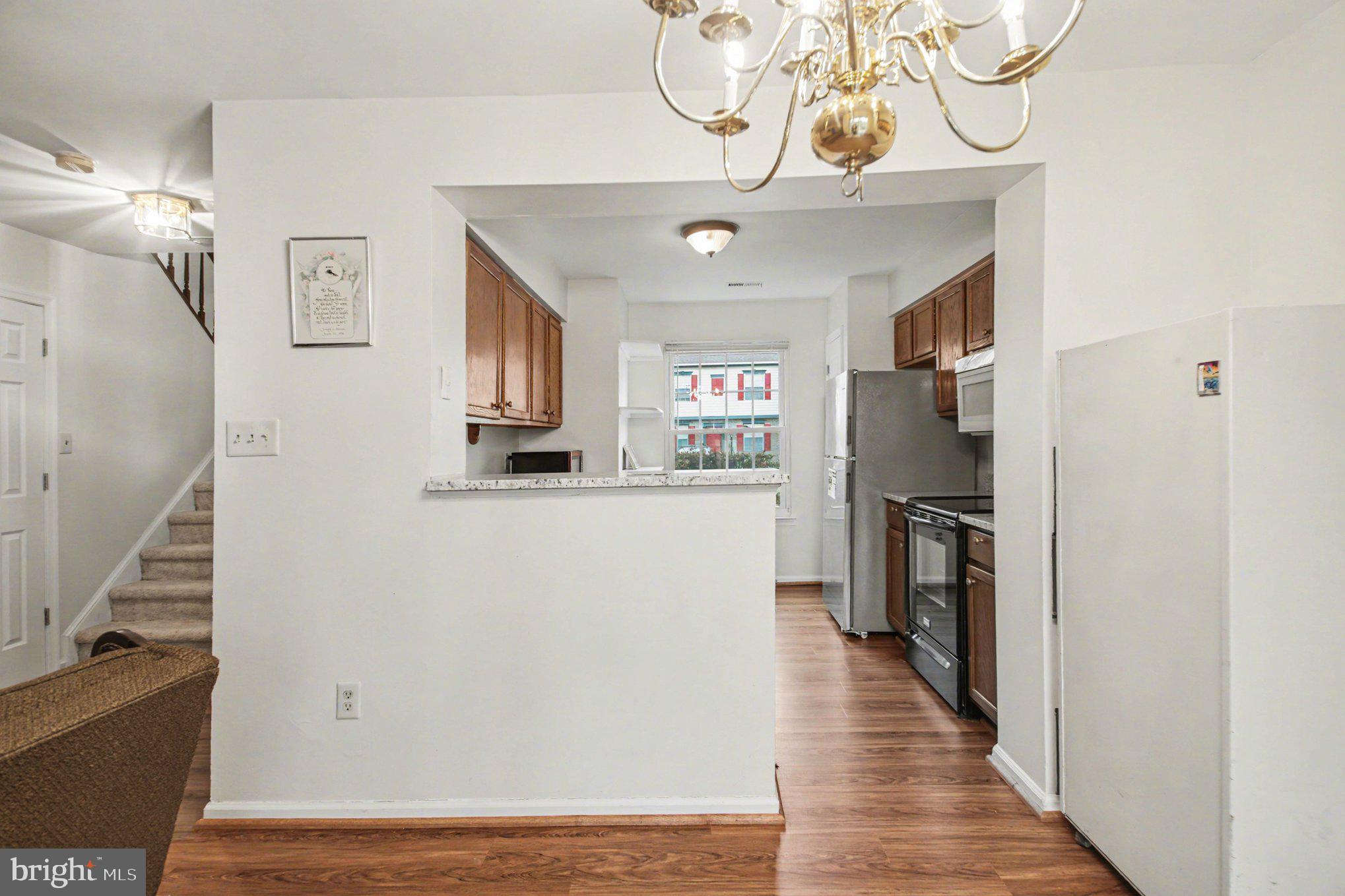 211 Wind Ridge Drive Stafford, VA 22554 - Photo 7 of 27 a view of a hallway with wooden floor and staircase