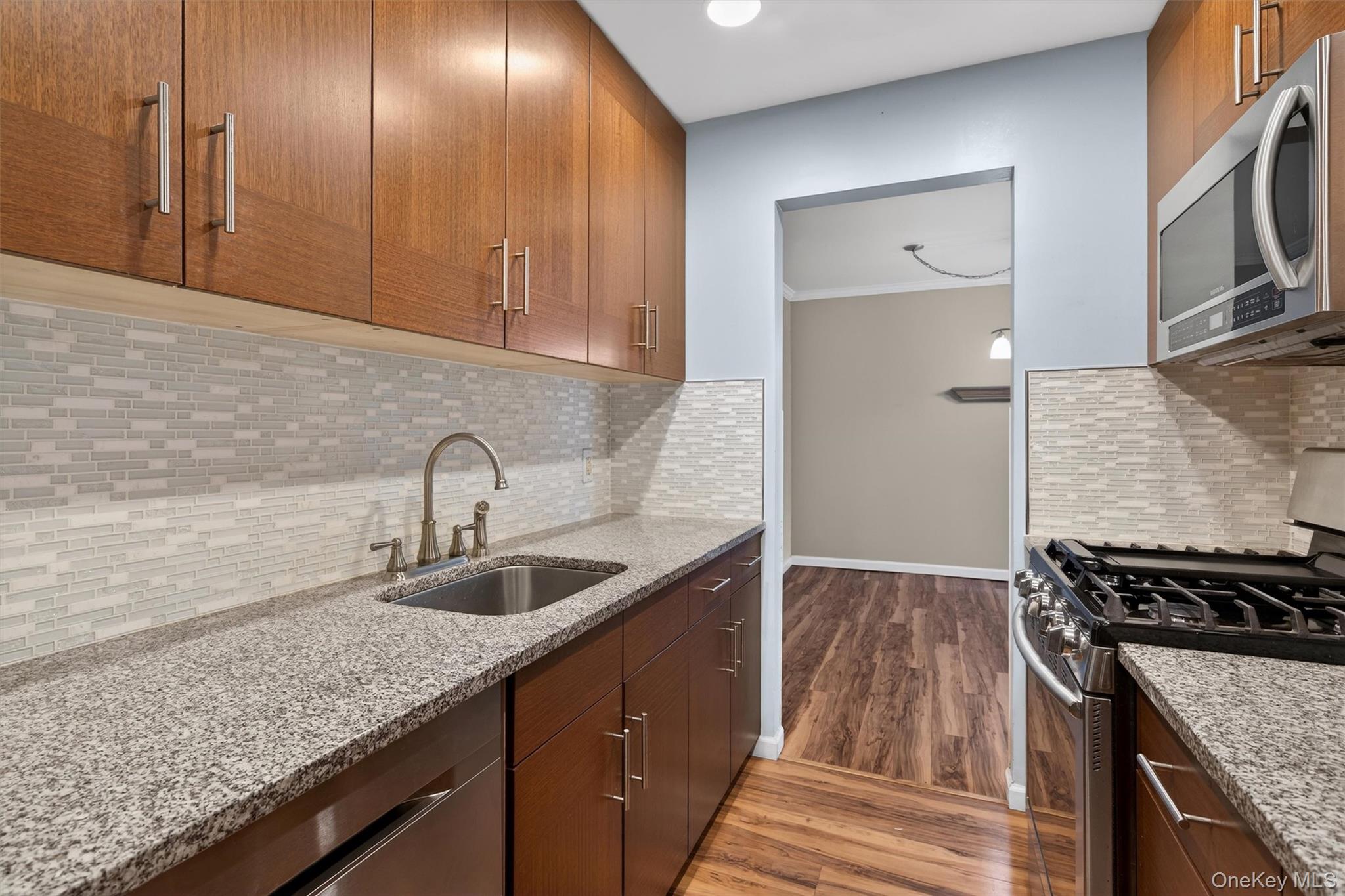 276 Temple Hill Road, Unit 2604 New Windsor, NY 12553 - Photo 11 of 31 a kitchen with granite countertop a sink stove and cabinets