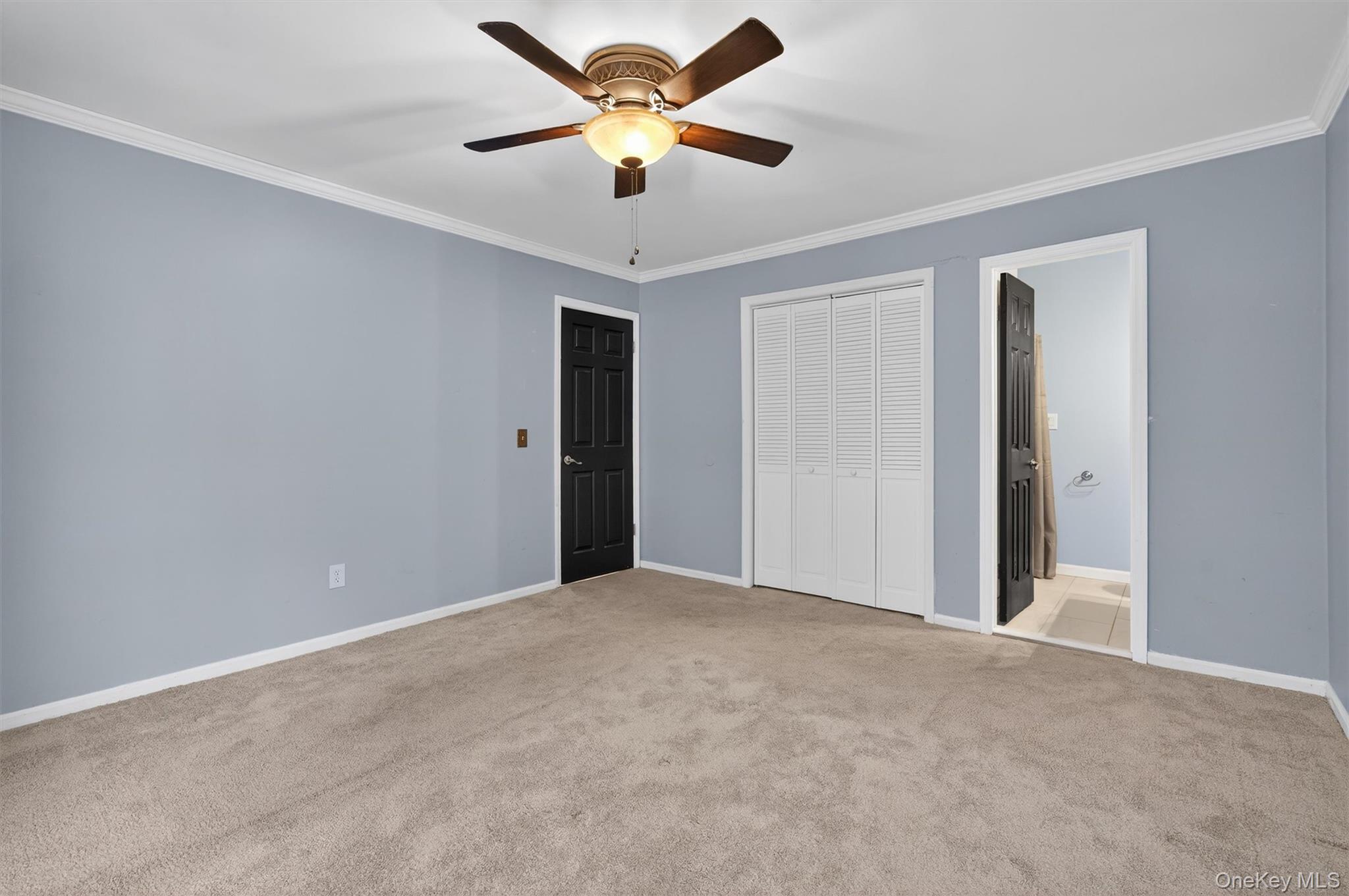 276 Temple Hill Road, Unit 2604 New Windsor, NY 12553 - Photo 19 of 31 Unfurnished bedroom featuring ornamental molding, a closet, carpet flooring, and a ceiling fan