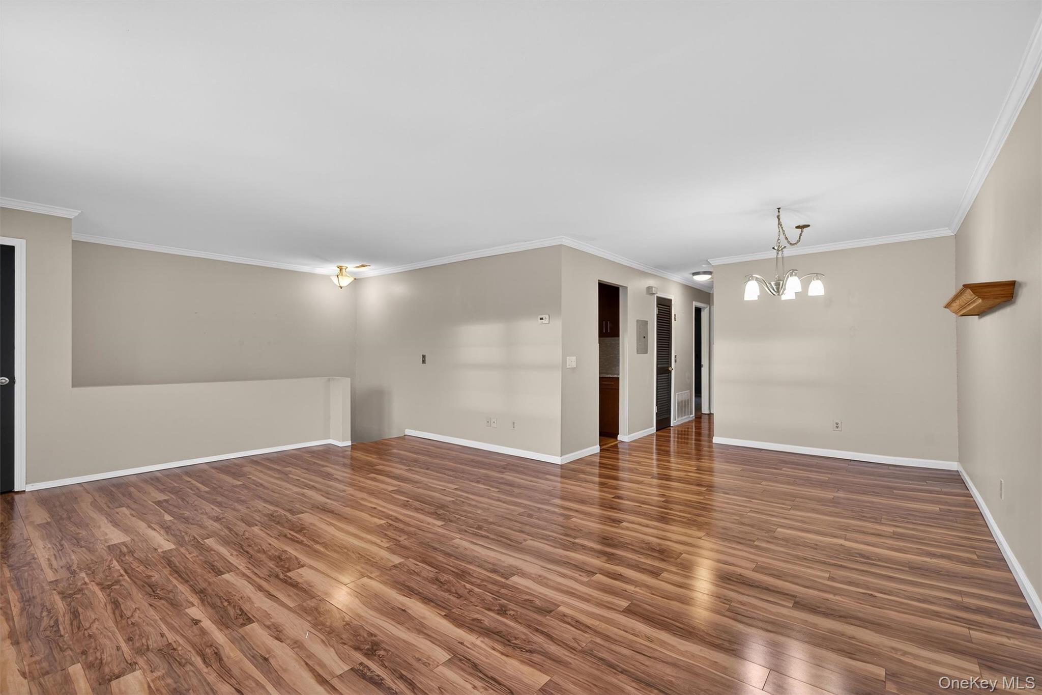 276 Temple Hill Road, Unit 2604 New Windsor, NY 12553 - Photo 2 of 31 a view of an empty room with wooden floor