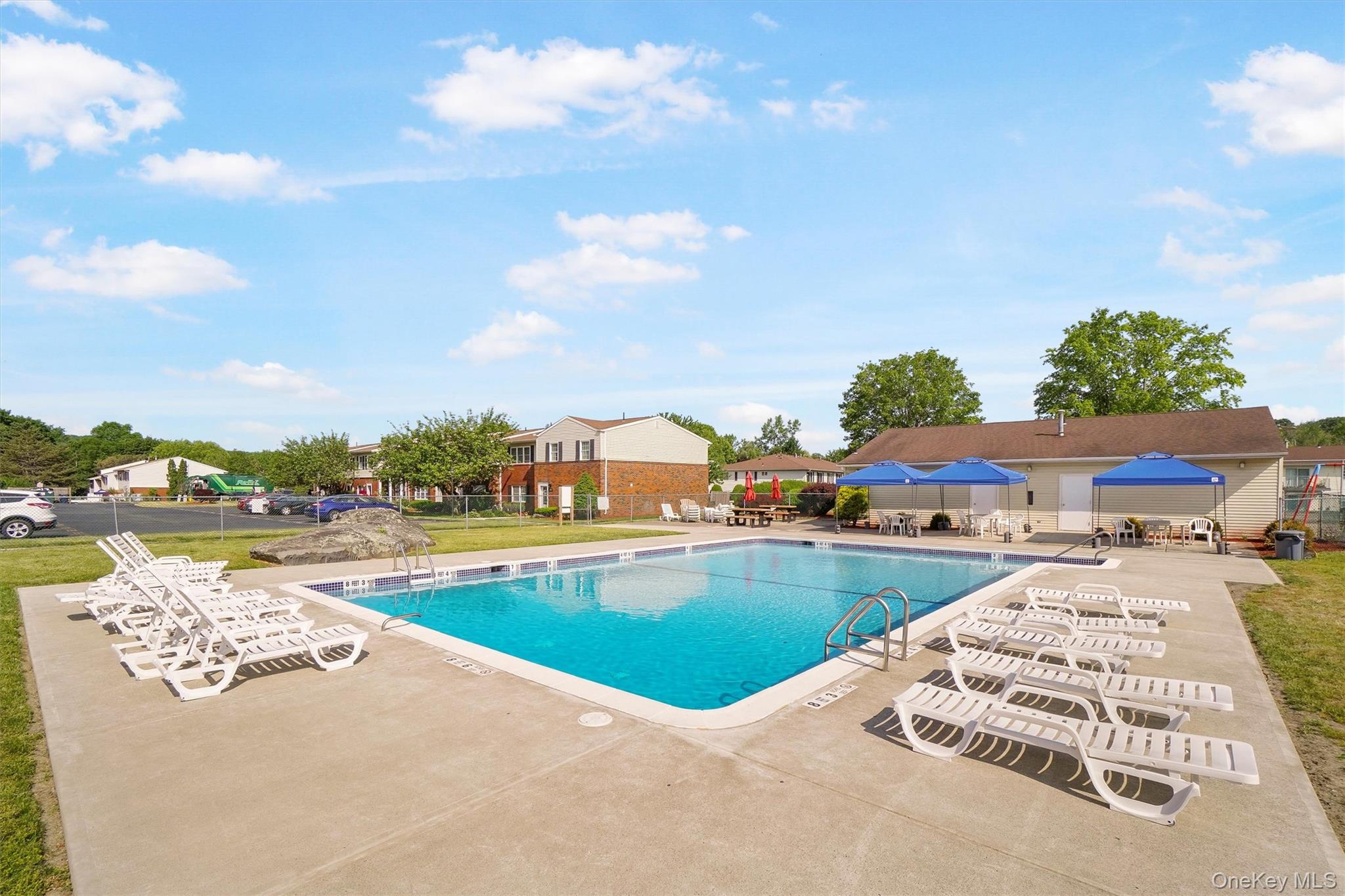 276 Temple Hill Road, Unit 2604 New Windsor, NY 12553 - Photo 28 of 31 a view of a swimming pool and lounge chair