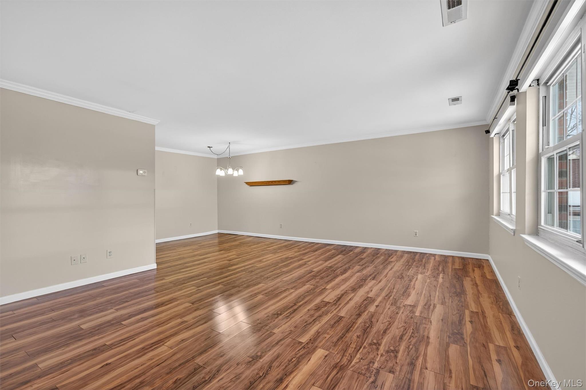 276 Temple Hill Road, Unit 2604 New Windsor, NY 12553 - Photo 3 of 31 wooden floor in an empty room with a window
