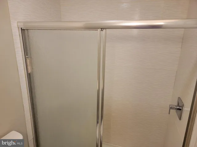 a bathroom with a glass shower door