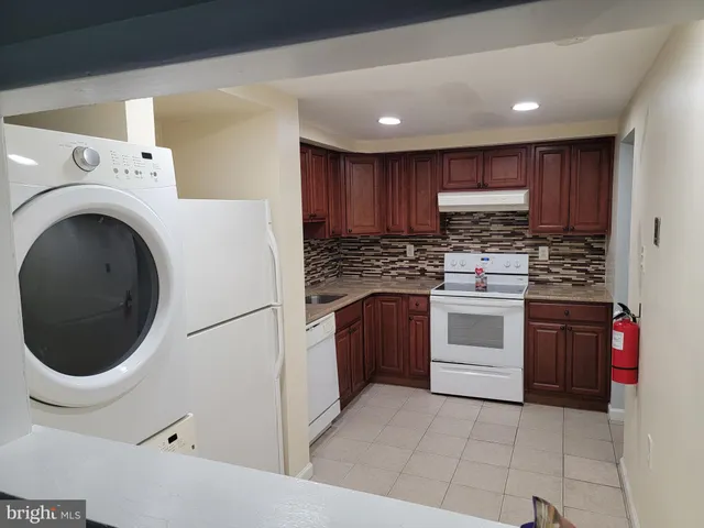 a kitchen with a stove top oven sink and cabinets