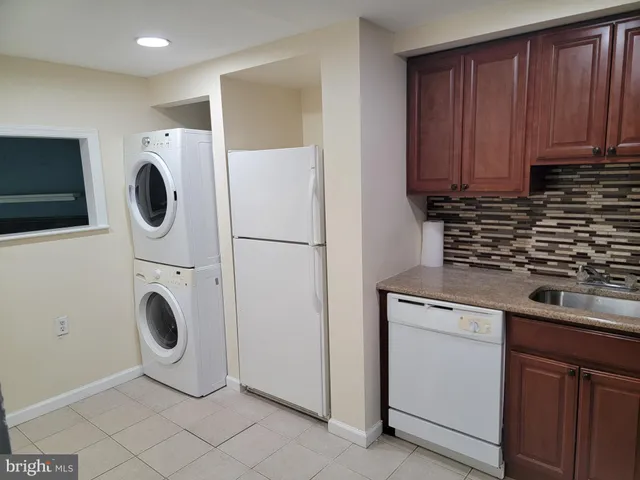 a kitchen with a refrigerator and a sink