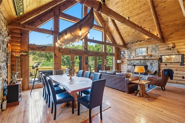 a view of a dining room with furniture wooden floor and a fireplace