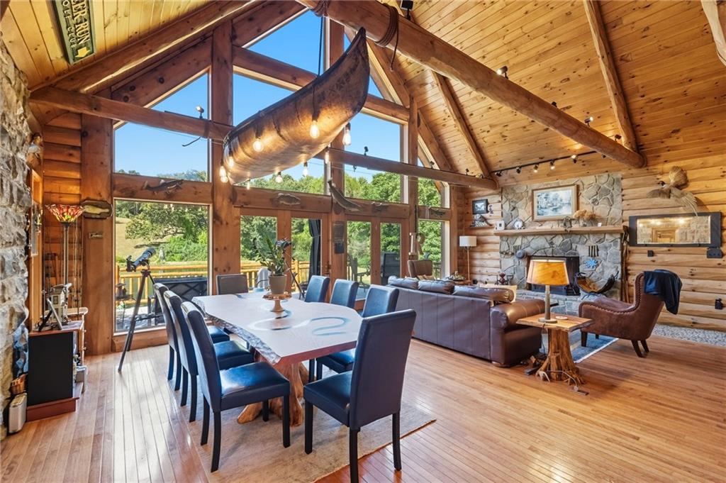 128 Courson Lane Emlenton, PA 16373 - Photo 17 of 50 a view of a dining room with furniture wooden floor and a fireplace