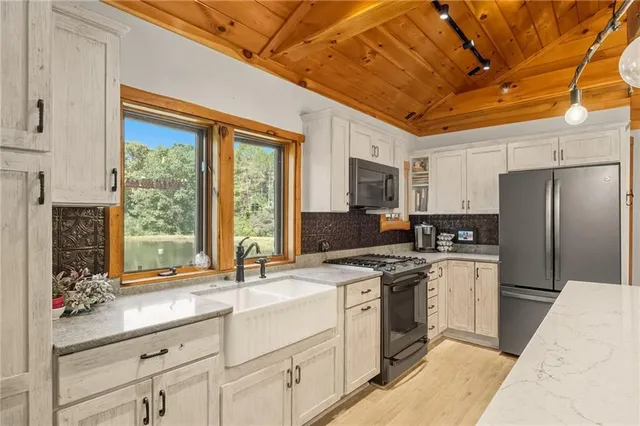 a kitchen with a sink stove and refrigerator