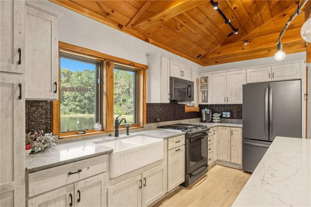 128 Courson Lane Emlenton, PA 16373 - Photo 22 of 50 a kitchen with a sink stove and refrigerator