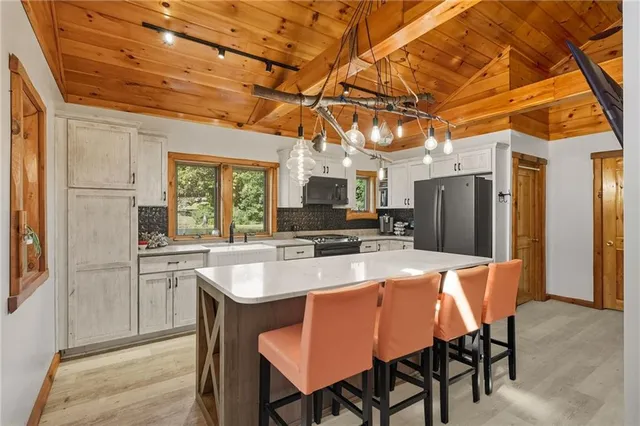 a dining table with chairs and kitchen view
