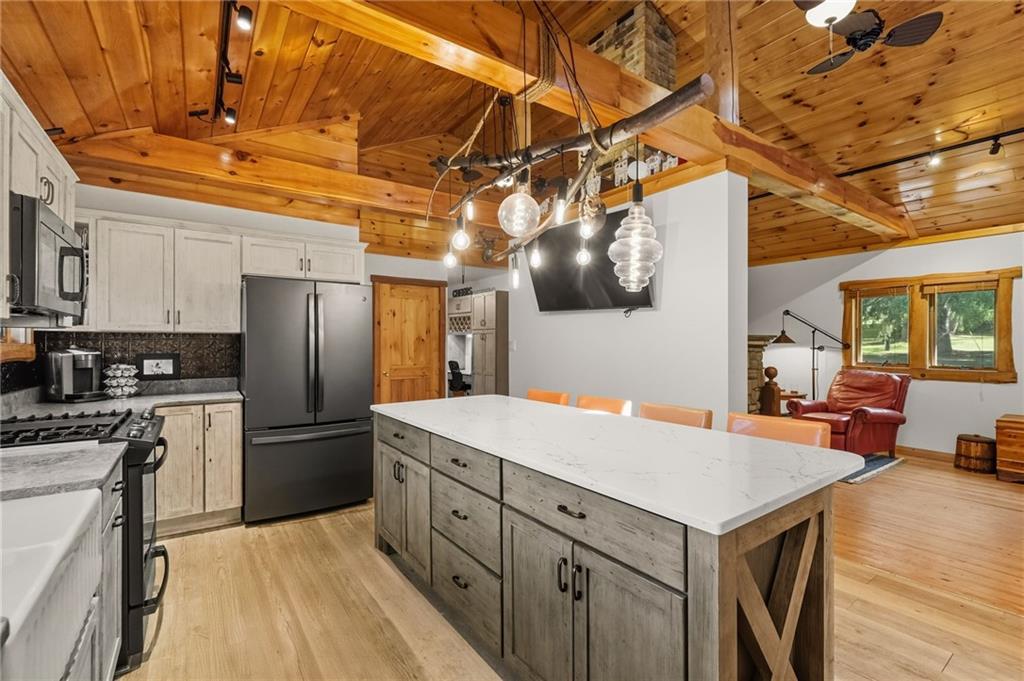128 Courson Lane Emlenton, PA 16373 - Photo 24 of 50 a kitchen with a refrigerator a sink dishwasher and a stove with wooden floor
