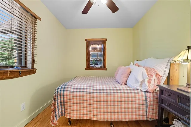 a bedroom with a bed and painting on the wall