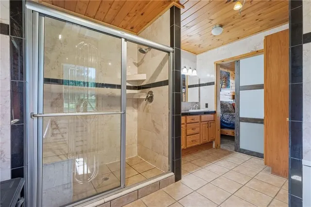 a bathroom with a glass shower door and mirror