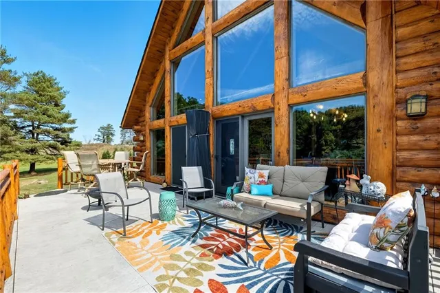 a view of an outdoor sitting area with furniture and umbrella