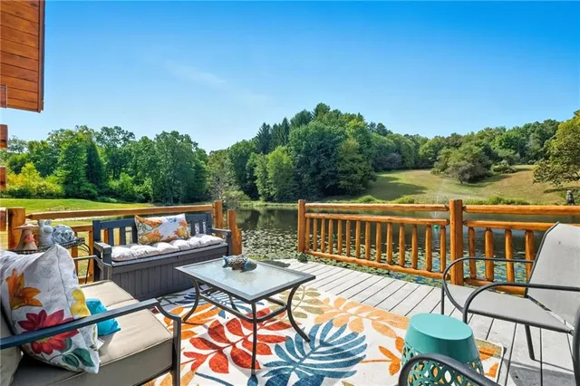 a view of a chairs and table on the roof deck