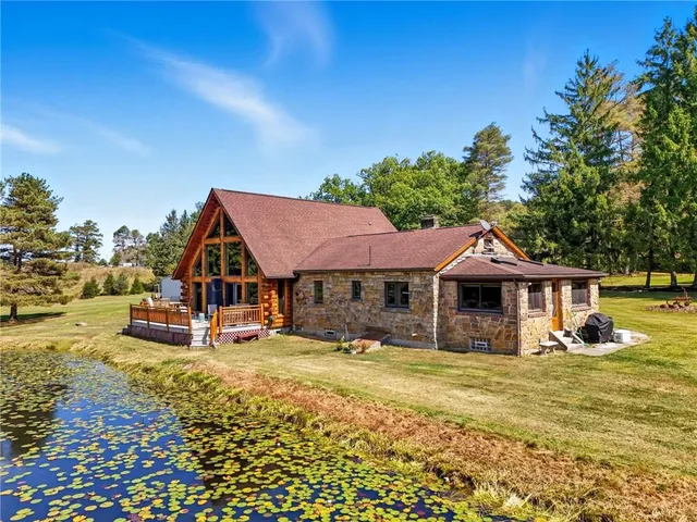 a front view of a house with a yard table and chairs