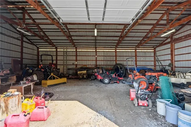 a view of a green field with wooden fence