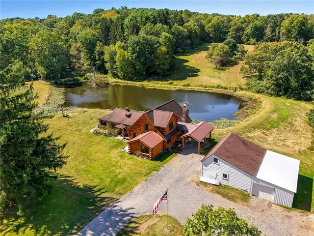 an aerial view of a house with a lake view