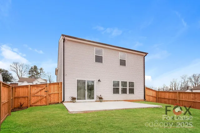 a view of an house with backyard space and balcony