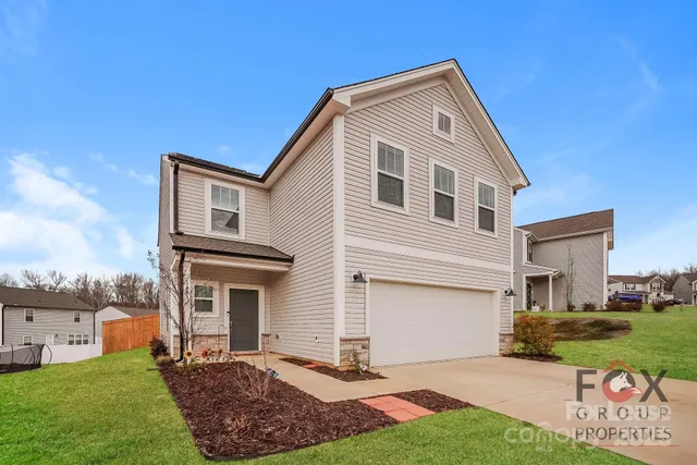 a view of a house with a backyard