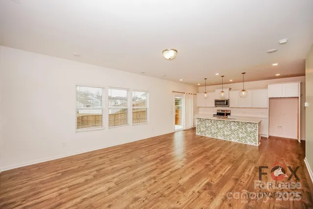 a view of a room with a ceiling fan and a window