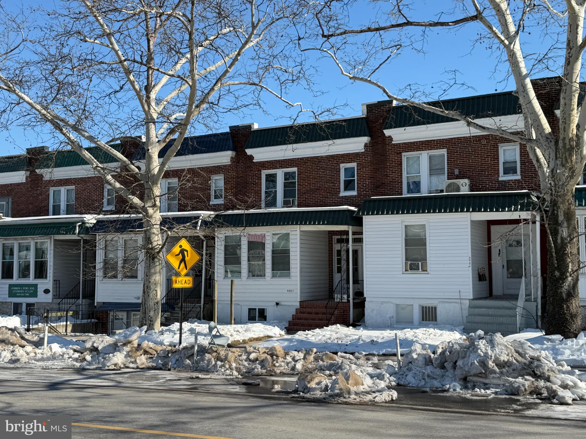 6927 Harford Road Baltimore, MD 21234 - Photo 2 of 2 Charming row homes under a winter sky.