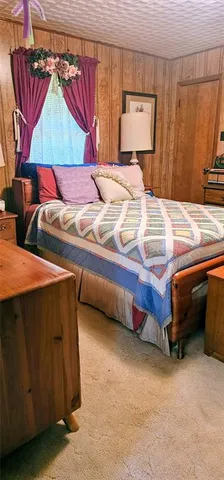 a bedroom with a bed and curtain