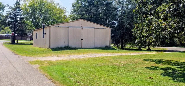 a view of a backyard with large trees