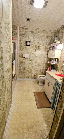 a bedroom with a bed and a mirror