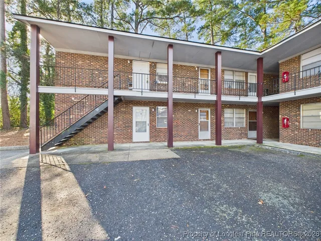 a view of parking area with large trees