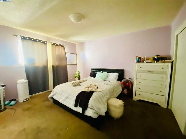 a bedroom with a bed and window