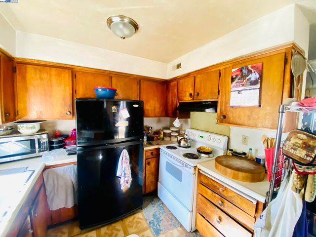 a kitchen with stainless steel appliances a stove refrigerator sink and cabinets
