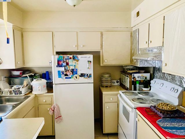 a kitchen with a stove a refrigerator and a sink