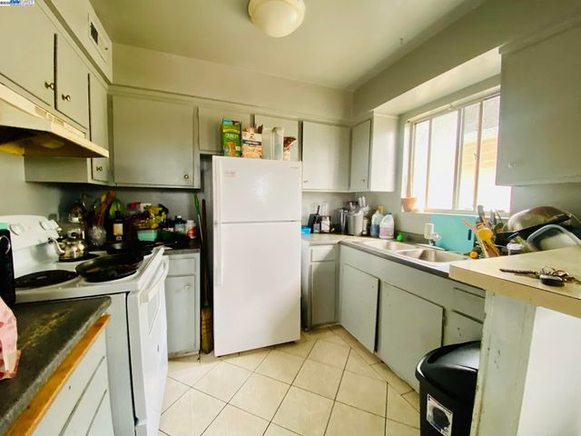 a kitchen with a refrigerator and a sink