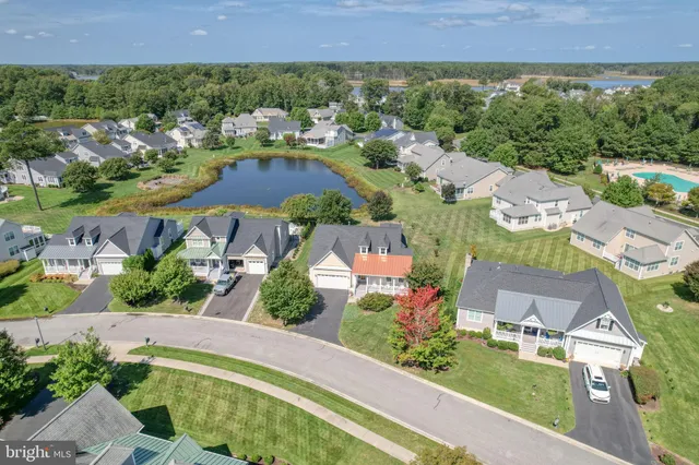 an aerial view of residential houses with outdoor space and street view