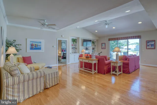 a kitchen with kitchen island granite countertop wooden cabinets a sink a stove a refrigerator and cabinetry