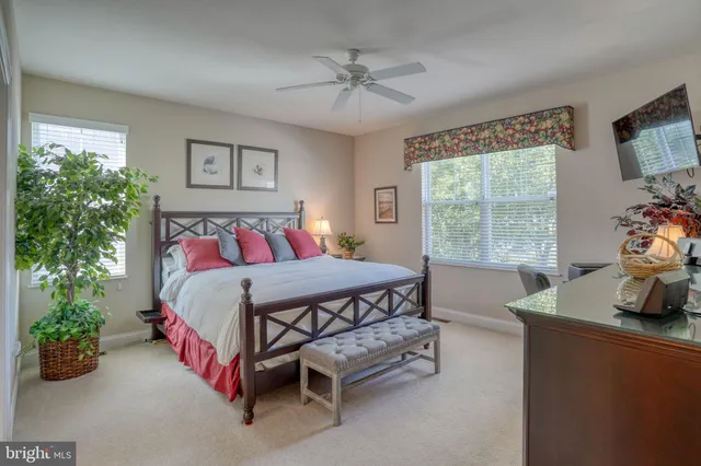 a kitchen with stainless steel appliances granite countertop a sink a stove a microwave oven and cabinets with wooden floor