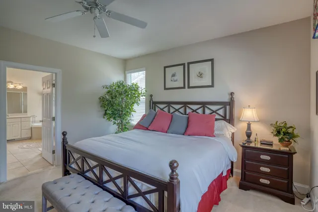 a kitchen with kitchen island granite countertop wooden cabinets a stove a sink and a white refrigerator